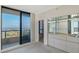 Bright living room featuring a sliding glass door to the balcony with scenic views at 1211 Gulf Of Mexico Dr # 701, Longboat Key, FL 34228
