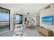 Bright living room with a dining area, balcony access, and views of the water at 1211 Gulf Of Mexico Dr # 701, Longboat Key, FL 34228