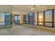Bright living room featuring floor-to-ceiling windows with stunning sunset views at 1211 Gulf Of Mexico Dr # 701, Longboat Key, FL 34228