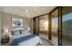 Inviting bedroom with a ceiling fan, balcony access, and views of the ocean at 1211 Gulf Of Mexico Dr # 701, Longboat Key, FL 34228