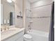 Well-lit bathroom with a shower-tub combination featuring modern fixtures and decorative tile accents at 12325 Marsh Pointe Rd, Sarasota, FL 34238