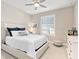 Comfortable bedroom featuring a ceiling fan, large window with shutters, and stylish decor at 12325 Marsh Pointe Rd, Sarasota, FL 34238
