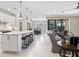 Open-concept kitchen featuring white cabinets, granite countertops, stainless steel appliances, and a breakfast bar with seating at 12325 Marsh Pointe Rd, Sarasota, FL 34238