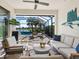 Outdoor seating area under a screened enclosure with a comfortable seating area overlooking a serene pool at 12325 Marsh Pointe Rd, Sarasota, FL 34238