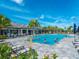 Resort-style community swimming pool with lounge chairs and tropical landscaping at 12325 Marsh Pointe Rd, Sarasota, FL 34238