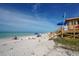Serene beach scene showcasing soft sand, turquoise water, and a lifeguard station under a blue sky at 132 Harrison Dr, Sarasota, FL 34236