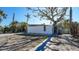 Modern exterior with unique architecture and mature trees offering shade and character to the property at 132 Harrison Dr, Sarasota, FL 34236
