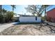 Modern home exterior with clean lines, a flat roof, ample parking space and minimal landscaping at 132 Harrison Dr, Sarasota, FL 34236