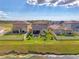 Aerial view of homes with well-manicured yards, water view, and fenced in yards at 13528 Sunset Sapphire Ct, Parrish, FL 34219