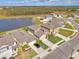 A neighborhood with a large pond, showing the beautifully-maintained lawns and landscaping at 13528 Sunset Sapphire Ct, Parrish, FL 34219
