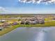 Aerial view of home overlooking lake in a serene, Gathering-friendly community at 13528 Sunset Sapphire Ct, Parrish, FL 34219