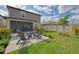 Spacious backyard with outdoor seating and lush landscaping overlooking the peaceful lake at 13528 Sunset Sapphire Ct, Parrish, FL 34219
