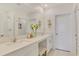 Bright bathroom features a double vanity, a large mirror, and a glass-enclosed shower at 13528 Sunset Sapphire Ct, Parrish, FL 34219