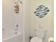 Charming bathroom featuring white subway tile, a nautical theme, and stylish fixtures at 13528 Sunset Sapphire Ct, Parrish, FL 34219