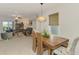 Dining area with a wooden table, stylish chairs, and scenic views, adjacent to the living room at 13528 Sunset Sapphire Ct, Parrish, FL 34219
