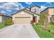 Charming two-story home with a well-maintained lawn, lush landscaping, and a spacious two-car garage at 13528 Sunset Sapphire Ct, Parrish, FL 34219