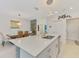 Open kitchen with an island overlooking the dining area offers modern style and convenience for entertaining at 13528 Sunset Sapphire Ct, Parrish, FL 34219