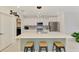 Modern kitchen features a spacious island, white cabinets, and stainless-steel appliances for a sleek look at 13528 Sunset Sapphire Ct, Parrish, FL 34219