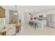 Bright kitchen with a large island, modern cabinetry, and an open design that connects to the dining area at 13528 Sunset Sapphire Ct, Parrish, FL 34219
