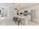 Bright kitchen boasts white cabinetry, stainless appliances, and a large center island with counter seating at 13528 Sunset Sapphire Ct, Parrish, FL 34219