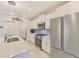 Stylish kitchen featuring an island with sink, modern appliances, and white cabinetry for a clean aesthetic at 13528 Sunset Sapphire Ct, Parrish, FL 34219