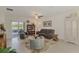 Inviting living room with plush seating, a decorative rug, and sliding glass doors to the outdoor area at 13528 Sunset Sapphire Ct, Parrish, FL 34219