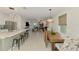 Open-concept design, seamlessly blending a kitchen, dining area, and living room with natural lighting and neutral tones at 13528 Sunset Sapphire Ct, Parrish, FL 34219