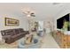 Spacious living area with comfortable seating, modern decor, and an open flow to the dining and kitchen areas at 13528 Sunset Sapphire Ct, Parrish, FL 34219