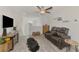 Cozy entertainment room with recliners, wood-look flooring, and a ceiling fan at 13528 Sunset Sapphire Ct, Parrish, FL 34219