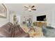 Open living space with a leather sofa, decorative rug, and adjacent dining and kitchen areas at 13528 Sunset Sapphire Ct, Parrish, FL 34219