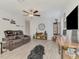 Relaxing living room features a large sofa, wood-look floors, and stylish accents at 13528 Sunset Sapphire Ct, Parrish, FL 34219