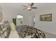 The spacious bedroom is filled with natural light and features a tranquil lake view from the window at 13528 Sunset Sapphire Ct, Parrish, FL 34219