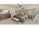Bedroom features a decorative headboard, coordinating nightstands, and ample natural light for a relaxing space at 13528 Sunset Sapphire Ct, Parrish, FL 34219