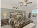 This bedroom boasts calming decor, side tables, and a decorative headboard offering a serene escape at 13528 Sunset Sapphire Ct, Parrish, FL 34219