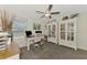 Bright office space with dual workstations, bookshelves, and large windows at 13528 Sunset Sapphire Ct, Parrish, FL 34219