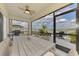 Screened lanai featuring a dining area with a view of the lake and outdoor seating at 13528 Sunset Sapphire Ct, Parrish, FL 34219