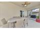 Covered patio with ceiling fan, table and chairs, offering a comfortable outdoor dining space at 13528 Sunset Sapphire Ct, Parrish, FL 34219