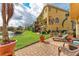 Resort-style backyard with brick patio, lush landscaping, and serene lake views at 1522 3Rd Street E Cir, Palmetto, FL 34221