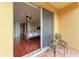 View from patio into primary bedroom, which features hard wood floors and dark wood furniture at 1522 3Rd Street E Cir, Palmetto, FL 34221