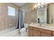 Well-lit bathroom featuring a shower/tub, tile flooring, and single vanity with cabinet storage at 1522 3Rd Street E Cir, Palmetto, FL 34221