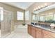 Large bathroom featuring a glass shower, soaking tub, and vanity with granite counters at 1522 3Rd Street E Cir, Palmetto, FL 34221
