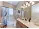 This full bathroom has an oak vanity with a white countertop and matching backsplash at 1522 3Rd Street E Cir, Palmetto, FL 34221