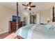 Spacious primary bedroom featuring hardwood floors, ceiling fan, and dark wood furniture at 1522 3Rd Street E Cir, Palmetto, FL 34221
