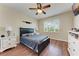 Bright bedroom with dark furniture and a ceiling fan at 1522 3Rd Street E Cir, Palmetto, FL 34221