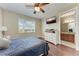 Bright bedroom featuring hardwood floors, a ceiling fan, and a view from the window at 1522 3Rd Street E Cir, Palmetto, FL 34221