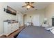 Bedroom featuring a TV, ceiling fan, hard wood floors, and direct access to a bathroom at 1522 3Rd Street E Cir, Palmetto, FL 34221
