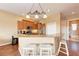 This well-lit kitchen features light wood cabinets, granite countertops, and a breakfast bar for casual dining at 1522 3Rd Street E Cir, Palmetto, FL 34221