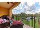 Enjoy outdoor living on this covered patio with brick flooring and a view of the lush landscaping and peaceful lake at 1522 3Rd Street E Cir, Palmetto, FL 34221
