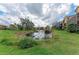 Picturesque pond view with lush landscaping and manicured grounds surrounding the home at 1522 3Rd Street E Cir, Palmetto, FL 34221