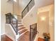 Elegant staircase with dark metal railings and wood treads, featuring a decorative sign and plant at 1522 3Rd Street E Cir, Palmetto, FL 34221